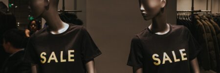two mannequins with black Sale graphic crew-neck t-shirts